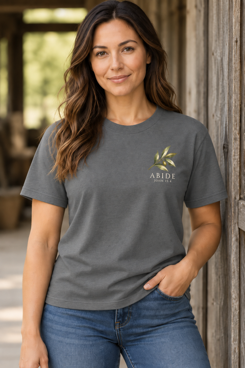 Woman wearing gray Abide John 15:4 faith tee with olive branch chest graphic