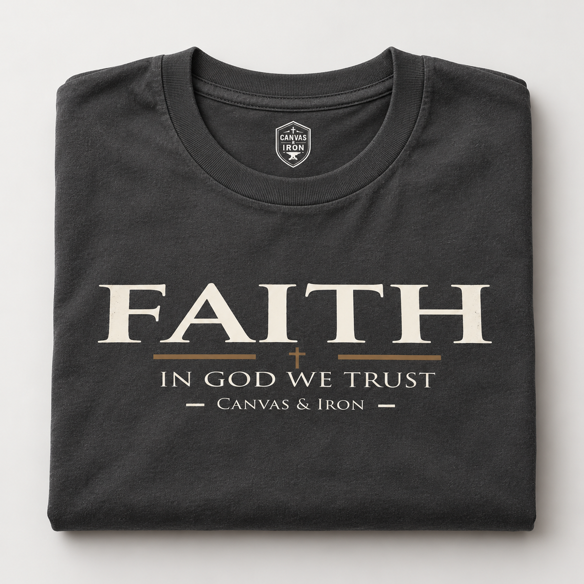 Folded black Faith Enhanced Tee with In God We Trust front graphic and Canvas & Iron neck mark